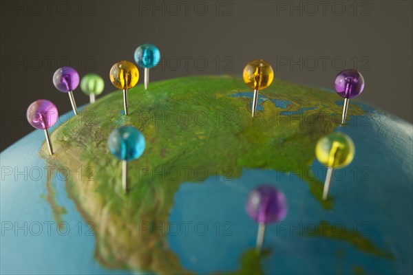 Push pins on globe. Photo. Mike Kemp