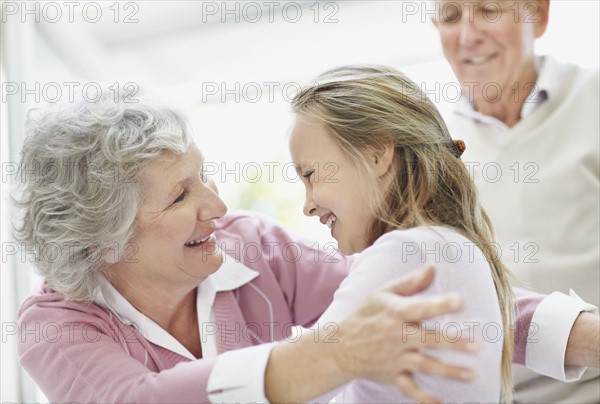 Granddaughter hugging her grandmother. Photo. momentimages