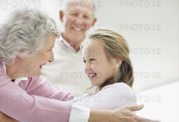 Granddaughter hugging her grandmother. Photo. momentimages