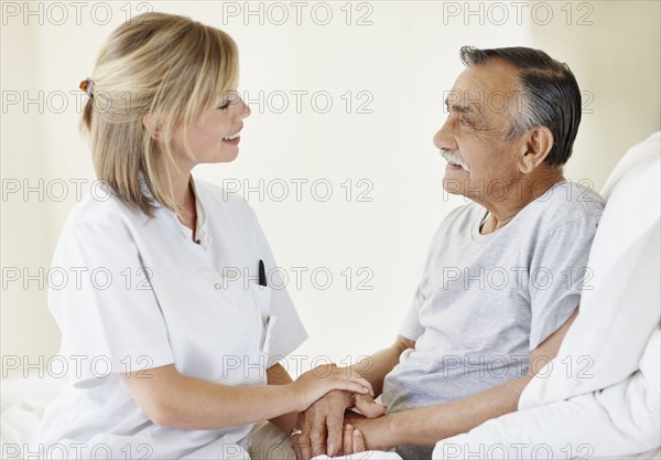 Nurse sitting with patient. Photo. momentimages