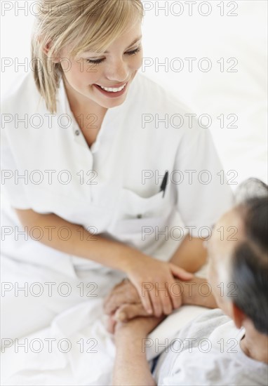 Nurse sitting with patient. Photo. momentimages