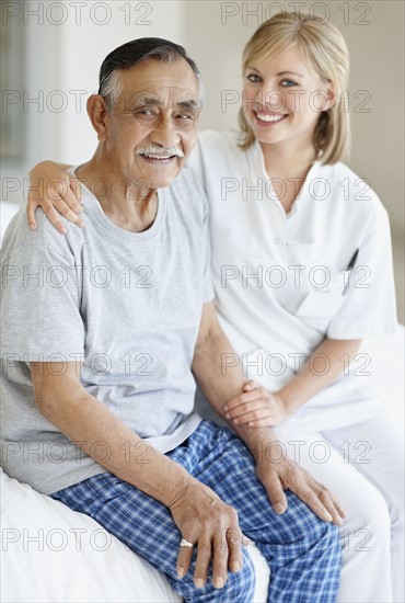 Nurse sitting with patient. Photo. momentimages