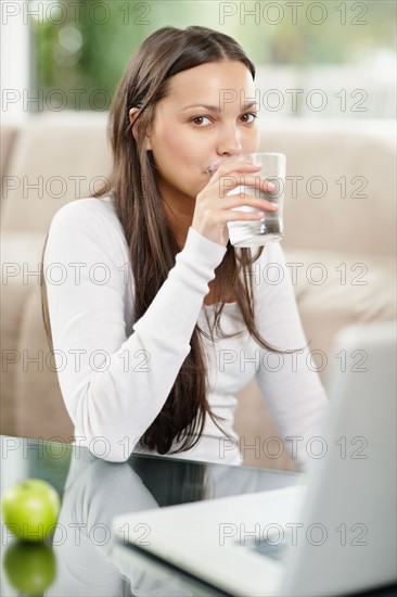 Woman drinking a glass of water. Photo. momentimages