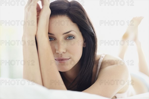 Sexy woman lying on bed. Photo. momentimages