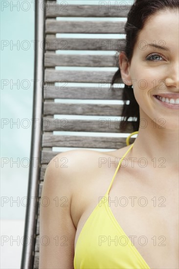 Brunette woman sunbathing. Photo. momentimages