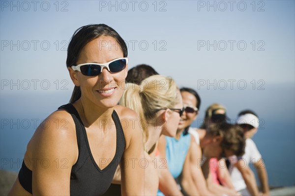 Runners resting on the side of the road.