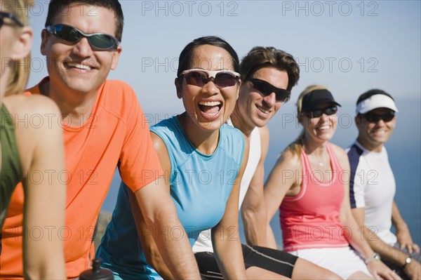 Runners resting on the side of the road.