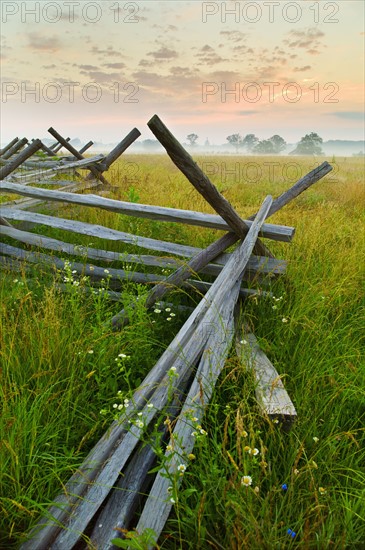 Rustic fence in field.