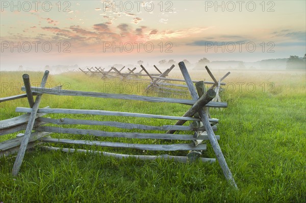 Rustic fence in field.