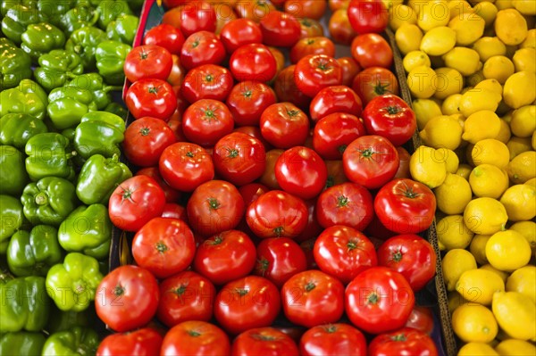 Display of peppers tomatoes and lemons.