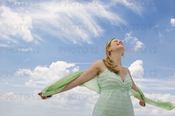 Blond woman walking outside.