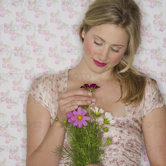 Pretty woman holding flowers.