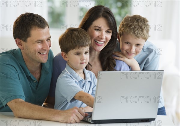 Family looking at laptop.