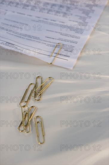 Paper clips and document. Photo. Daniel Grill