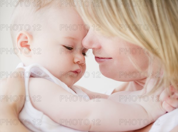 Mother embracing her baby daughter. Photo : Jamie Grill