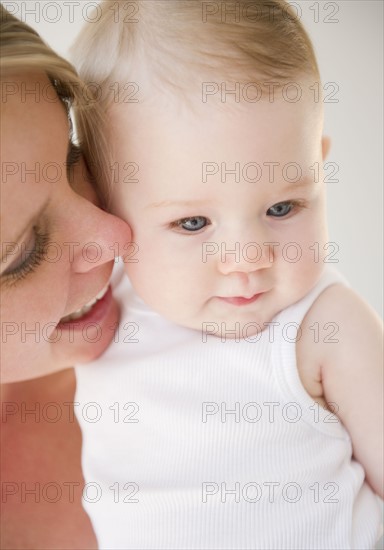 Mother holding her baby daughter. Photo. Jamie Grill