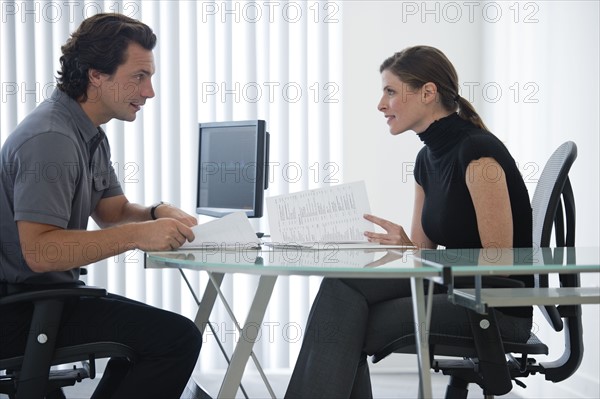 Man and woman working at desk.