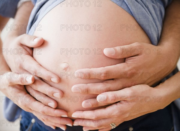 Young man hugging pregnant woman. Photo : Jamie Grill