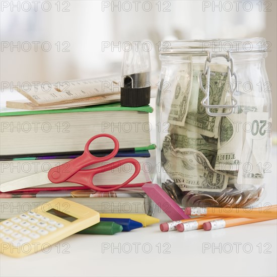 Stationery and jar of money. Photo : Jamie Grill
