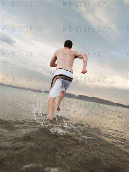 Man running on beach.