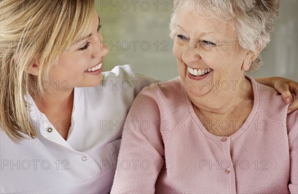 Daughter and mother looking each other. Photo : Momentimages