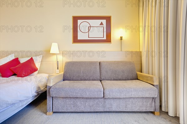 Sofa beside bed in luxury home. Photo : Jon Boyes