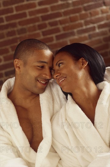 Happy couple wearing bathrobes. Photo : Fisher Litwin