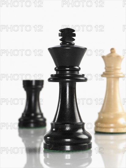 King chess piece with queen and rook in background. Photo : David Arky