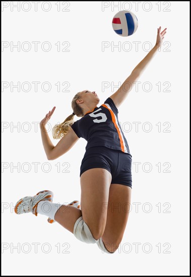 Young girl (16-17) playing volleyball. Photo : Mike Kemp