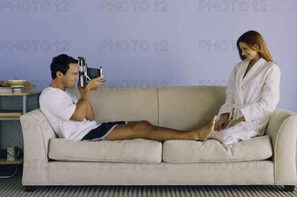 Man taking photograph of woman. Photo : Fisher Litwin