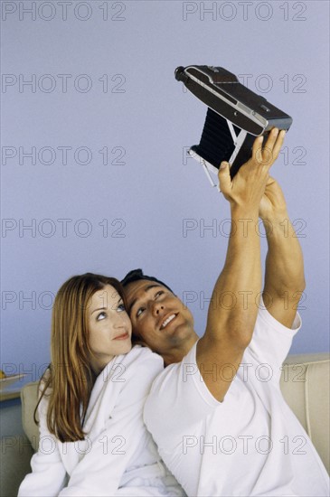 Playful couple taking self portrait. Photo : Fisher Litwin