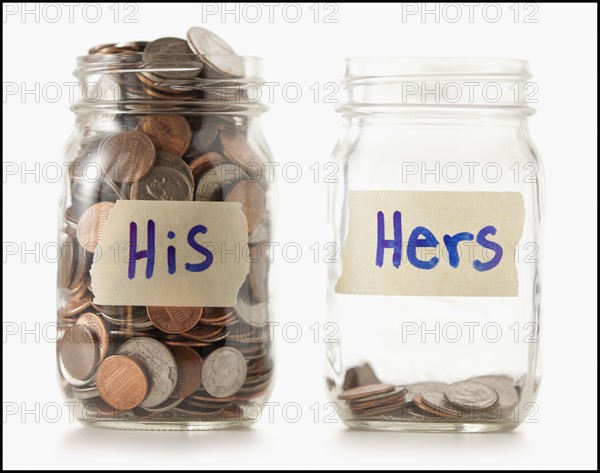 Studio shot of two jars with coins labeled "Hers" and "His". Photo : Mike Kemp