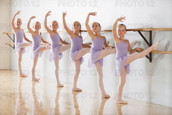 Row of female ballet dancers (6-8) in dance studio. Photo : Mike Kemp