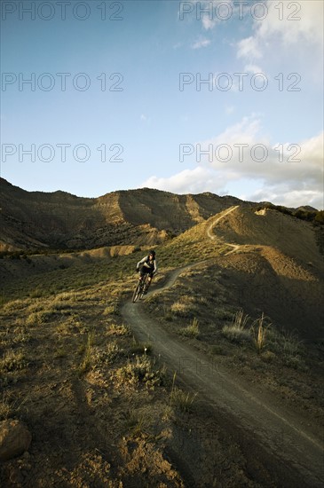 Man mountain biking on mountain track. Photo : Shawn O'Connor