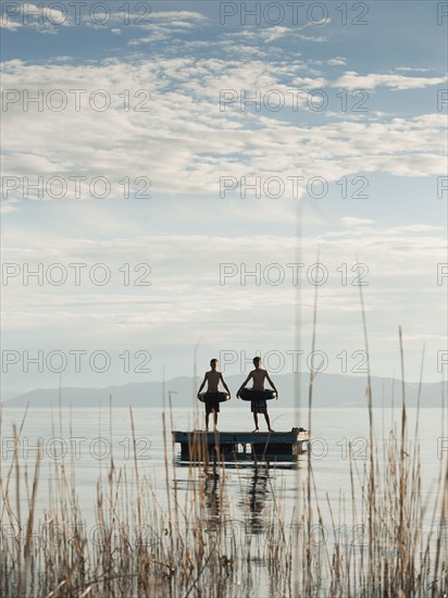 Boys (10-11,12-13) jumping from raft.