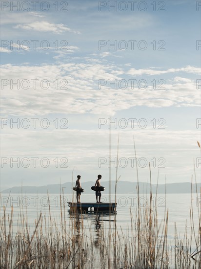 Boys (10-11,12-13) jumping from raft.