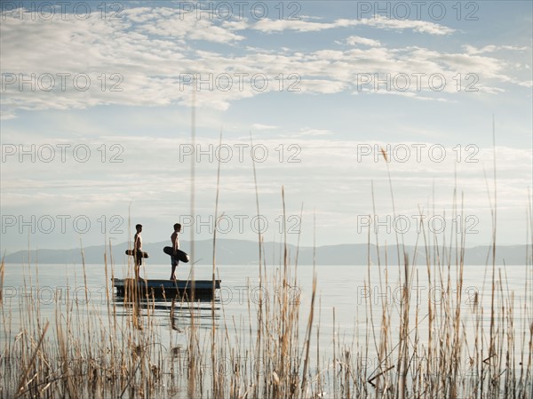 Boys (10-11,12-13) jumping from raft.