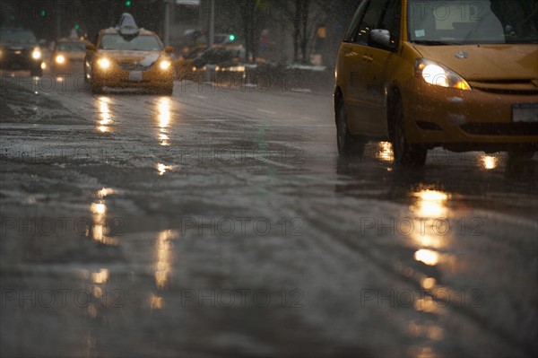 USA, New York, New York City, Traffic on street in snow, dusk.