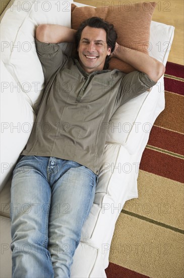 Man relaxing on sofa.