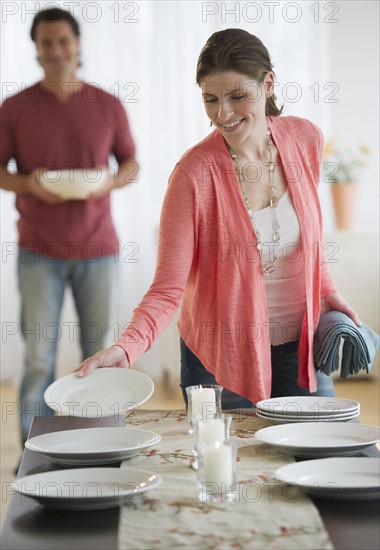 Couple preparing table.