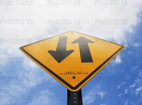 Road sign against sky, low angle view. Photo : fotog