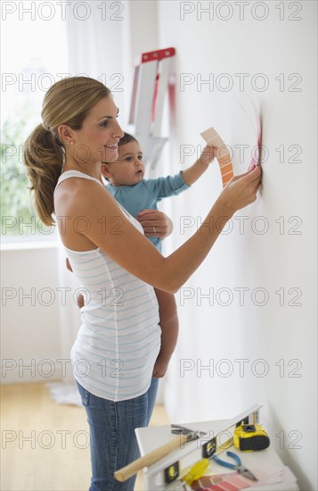Mother and daughter (12-18 months) choosing paint color.