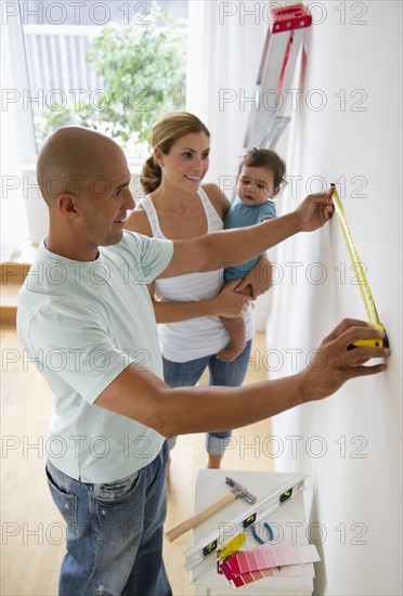 Young family with small girl (12-18 months) refurbishing room.