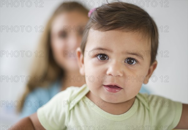 Mother and daughter (12-18 months) in bedroom.