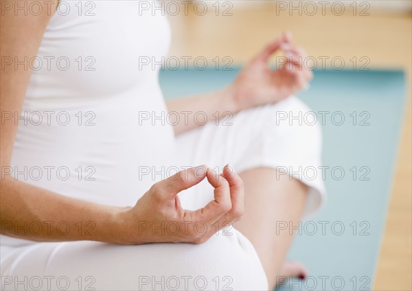 Young pregnant woman meditating. Photo : Jamie Grill