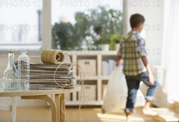 Boy (10-11) sorting garbage at home. Photo : Daniel Grill