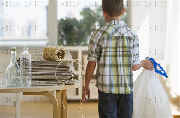 Boy (10-11) sorting garbage at home. Photo : Daniel Grill