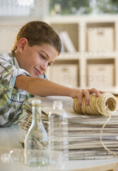 Boy (10-11) sorting garbage at home. Photo : Daniel Grill