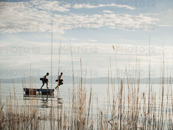 Boys (10-11,12-13) jumping from raft.