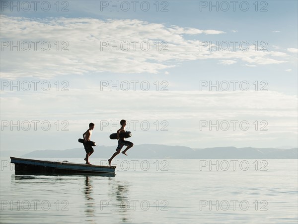 Boys (10-11,12-13) jumping from raft.